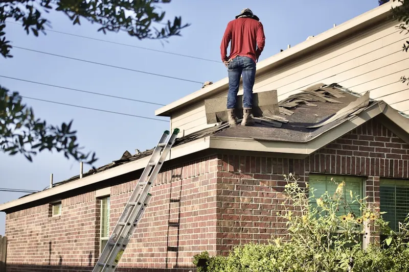 Professional roofer working on a residential roof in Fitzsimons